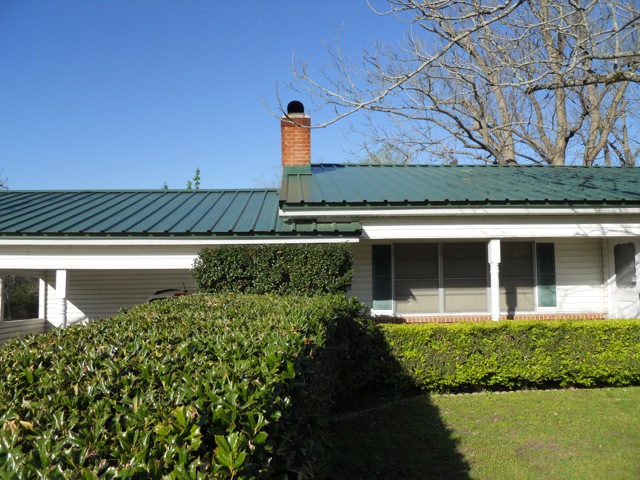 Picture from front of house showing completed metal reroof in green