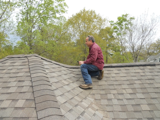 Alternative picture from rooftop of Grumbles team inspecting roof